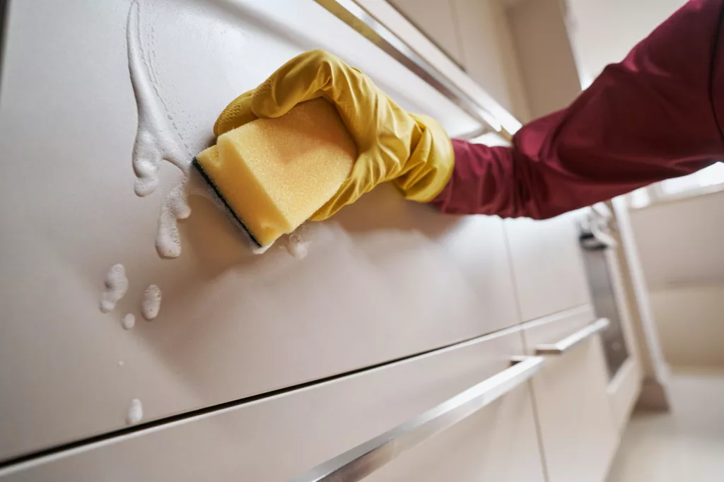 M&P Cleaning offers services of House Cleaning, Deep Cleaning, Airbnb Cleaning, Construction Cleaning, Move Out - In, Office Cleaning in Sausalito, CA, San Rafael, CA, Novato, CA, Tiburon, CA, Mill Valley, CA, Corte Madera, CA - House CleaningJanitor wiping down kitchen cabinet with cleaning solution